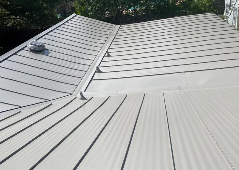 Solar attic fan installed on a metal roof for Roof Ventilation in Tuba City